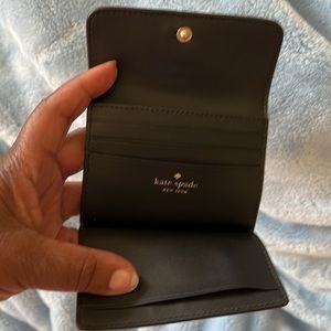 kate spade credit card case with chain wrist step and pull.  Zip pocket on back